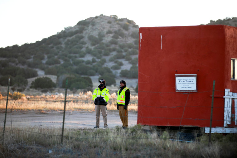 Image: Security guards stand near the entrance to Bonanza Creek Ranch in New Mexico.