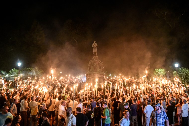 White nationalists march on the grounds of the University of Virginia ahead of the \"Unite the Right Rally\" in Charlottesville on Aug. 11, 2017.