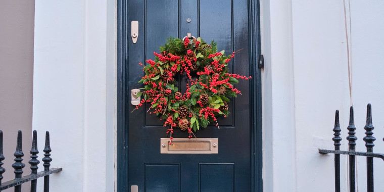 Christmas wreath hanging on house entrance door
