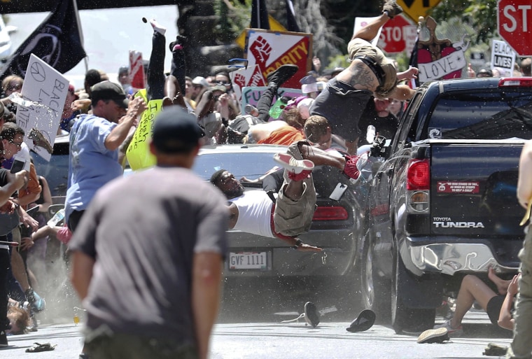 Image: People fly into the air as a vehicle drives into a group of protesters