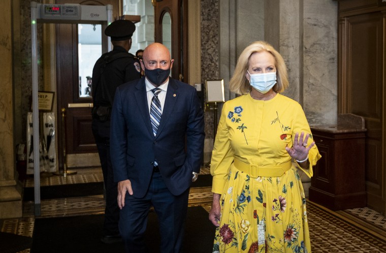 Sen. Mark Kelly escorts Cindy McCain into the Capitol as his guest for his maiden speech on the Senate floor on Aug. 4.