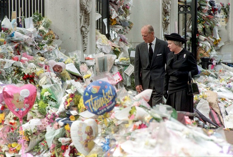 Queen Elizabeth II and the Duke of Edinburgh view the floral tributes to Diana, Princess of Wales, at Buckingham Palace on May 9, 1997.