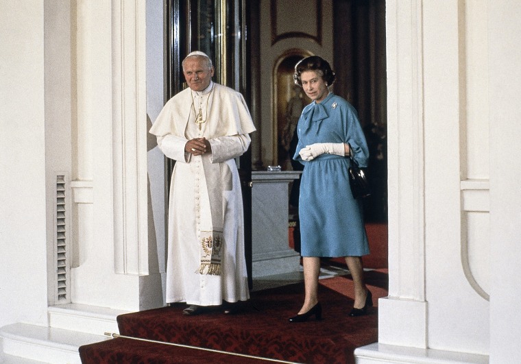 Pope John Paul II walks with Britain's Queen Elizabeth II at Buckingham Palace in London on May 28, 1982.