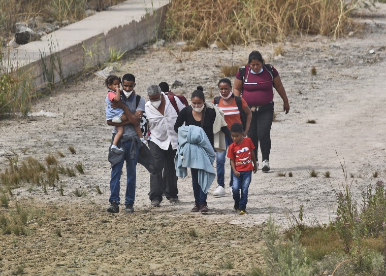 Migrants attempt to cross in to the U.S. from Mexico at the border on Oct. 7, 2021 in San Luis, Ariz.