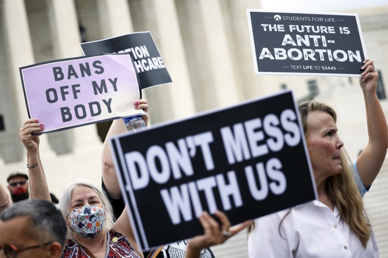Abortion rights and anti-abortion activists protest alongside each other outside of the Supreme Court on Oct. 4, 2021, in Washington.