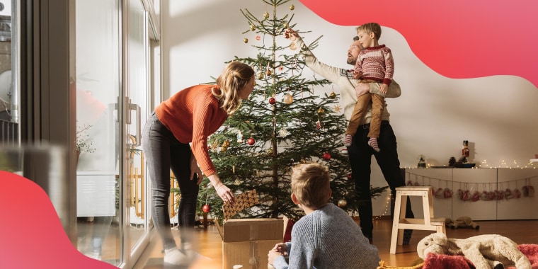 Young Family decorating Christmas tree