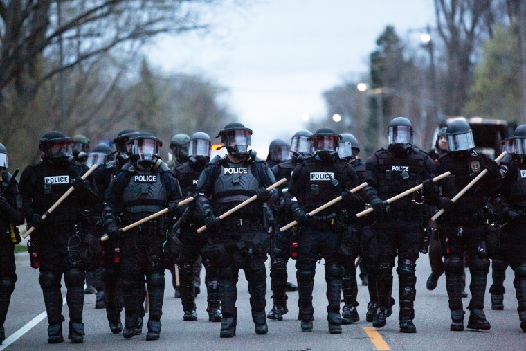 Minneapolis police officers stand in line during a protest in Brooklyn Center, Minneapolis, Minn., on April 11,2021.