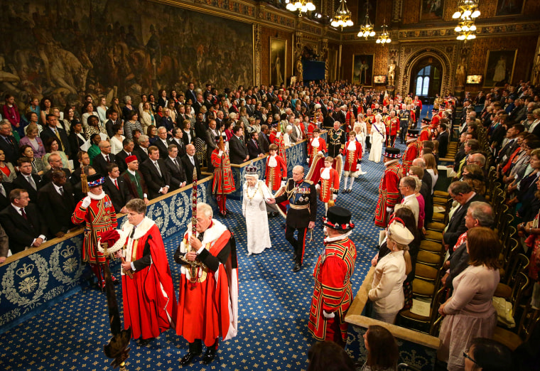 Britain's Queen Elizabeth II and Prince Philip proceed through the Royal Gallery during the State Opening of Parliament in the House of Lords at the Palace of Westminster in London on June 4, 2014.