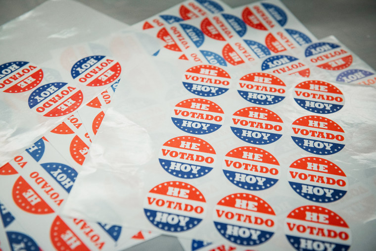 Sheets of stickers reading in Spanish \"I Voted Today\" are displayed on a table at a polling station inside a Baptist Church in Philadelphia on June 2, 2020.