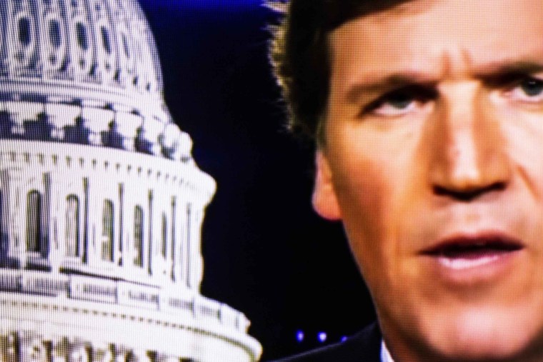 Image: Fox News anchor Tucker Carlson on a television screen in 2020.