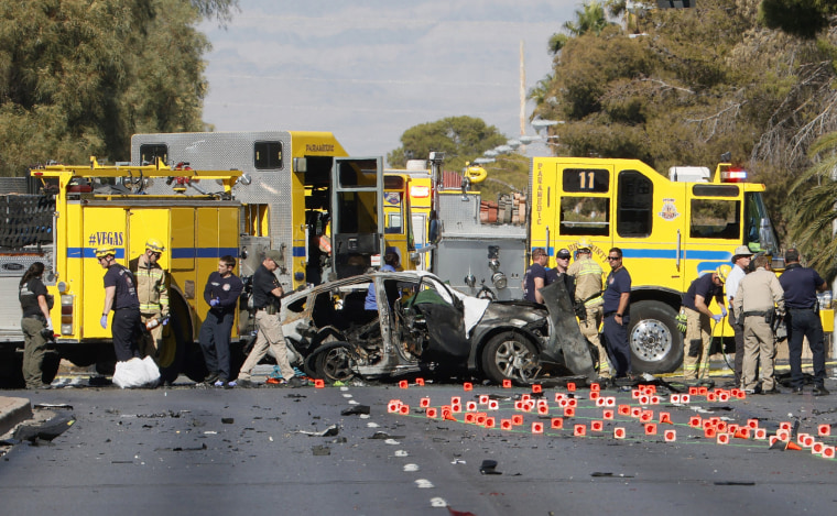 Image: Members of the Clark County Fire Department and the Las Vegas Metropolitan Police Department work the scene of a fatal accident on Nov. 2, 2021 in Las Vegas.