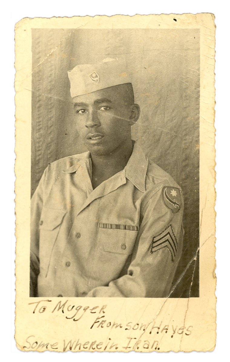 Image: Old photograph of a young man in army uniform. Handwritten text on it reads,"To Mugger. From Son, Hayes. Somewhere in Iran".