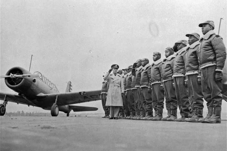 Major James A. Ellison, left, returns the salute of Mac Ross of Dayton, Ohio, as he inspects the cadets at the Basic and Advanced Flying School for Black United States Army Air Corps cadets at the Tuskegee Institute in Tuskegee, Ala., in Jan. 23, 1942.