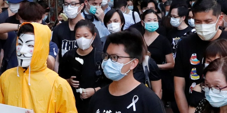 Ma Chun-man, center, a Hong Kong activist dubbed \"Captain America 2.0,\" attends a vigil for protester Marco Leung Ling-kit in Hong Kong on June 15, 2020.