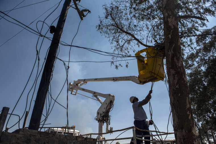 Image: Eskom workers cut illegal connections during a energy management and losses campaign in Gauteng, South Africa, on Sept. 29, 2020.