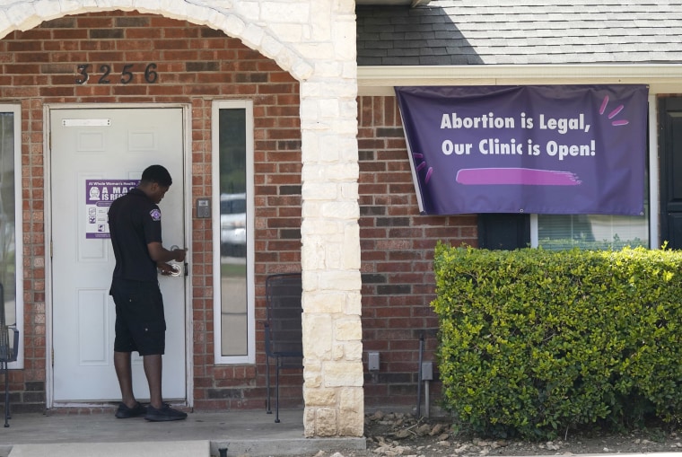 A security guard opens the door to the Whole Women's Health Clinic in Fort Worth, Texas, on Sept. 1, 2021. 