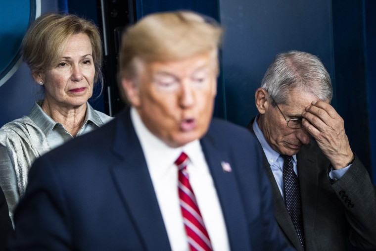 Dr. Deborah Birx and Dr. Anthony Fauci listen as President Donald Trump speaks during a Covid-19 briefing at the White House on March 20, 2020.