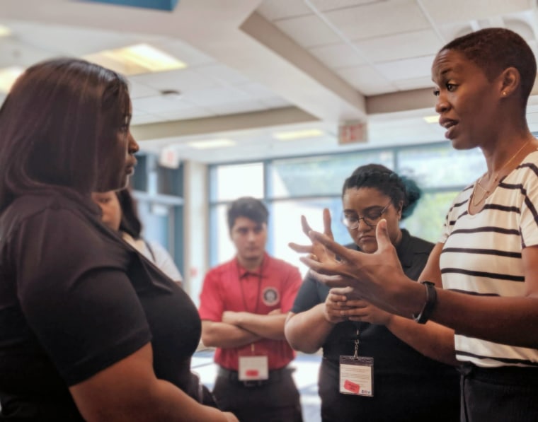 Candace Doby talks to a participant about courage after her keynote at the National Society of Leadership and Success conference in 2019.