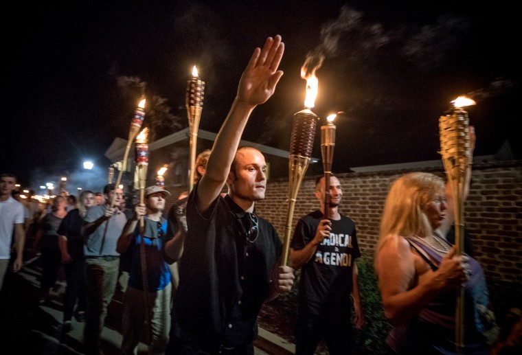 Image: White nationalists and white supremacists march through the University of Virginia campus in Charlottesville on Aug. 11, 2017.