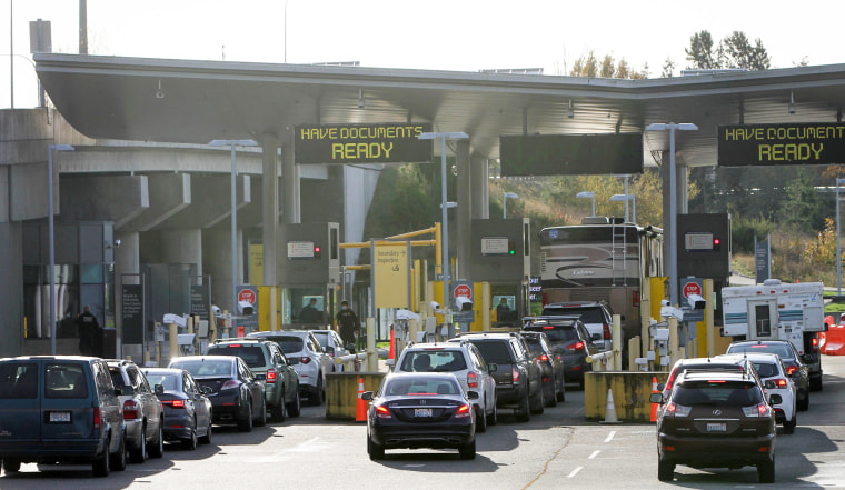 Vehicles from Canada line up to enter the United States at the Peace Arch border crossing in Surrey, British Columbia, on Nov. 8, 2021.