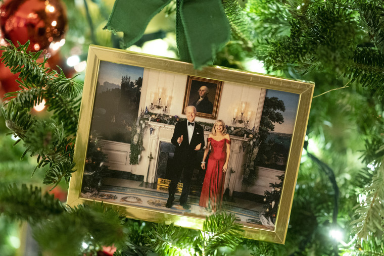 A photo of President Joe Biden and first lady Jill Biden sits in a Christmas tree in the State Dining Room of the White House during a press preview of the White House holiday decorations, Monday, Nov. 29, 2021, in Washington. (AP Photo/Evan Vucci)