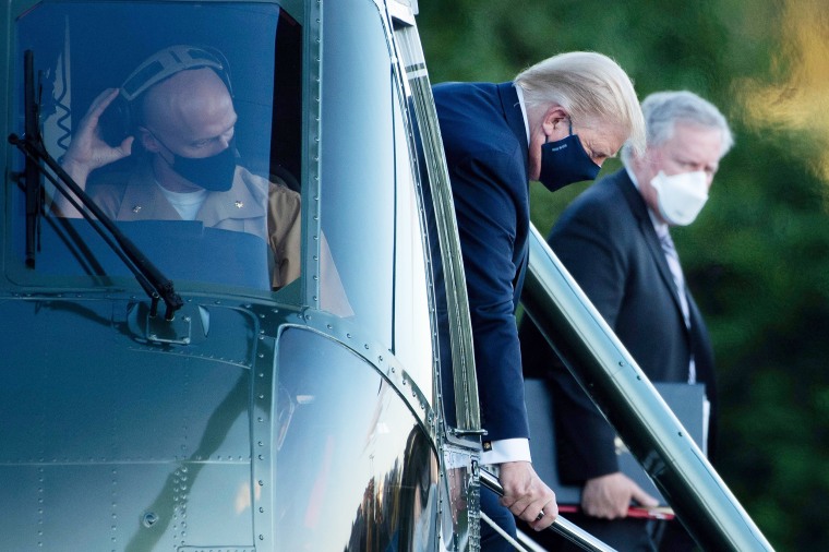 Image: President Donald Trump walks off Marine One while arriving at Walter Reed Medical Center in Bethesda, Md. on Oct. 2, 2020.