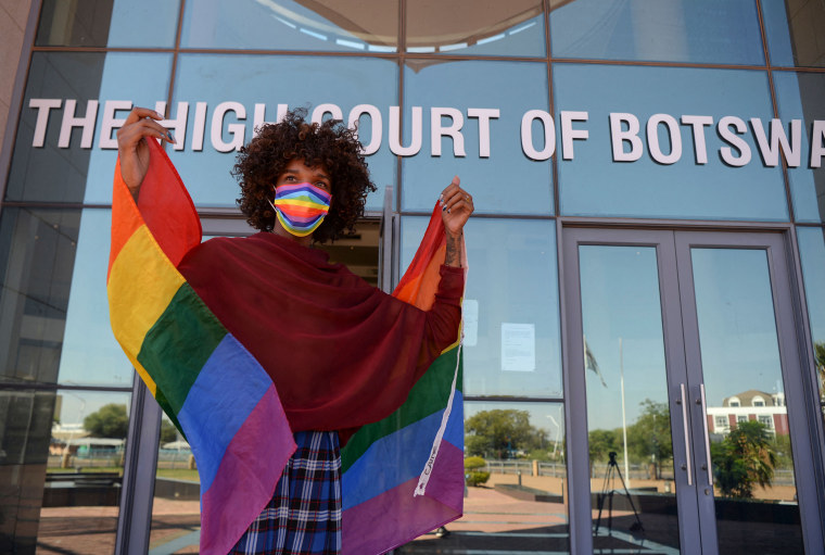 An activist holds a rainbow flag outside the Botswana High Court in Gaborone on Nov. 29, 2021.