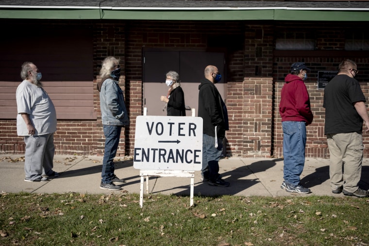 Voters wait in line outside a polling center on Election Day, in Kenosha, Wis., on Nov. 3, 2020.