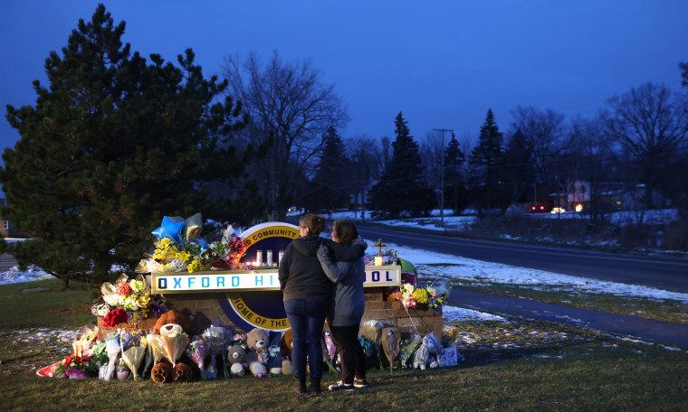 People visit a makeshift memorial outside of Oxford High School in Oxford, Michigan on Dec. 1.