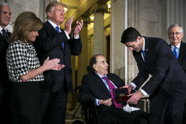Former Senate Majority Leader Bob Dole, center, is presented with the Congressional Gold Medal by House Speaker Paul Ryan, R-Wis., right, as U.S. President Donald Trump, center left, applauds during a ceremony at the Capitol on Jan. 17, 2018.