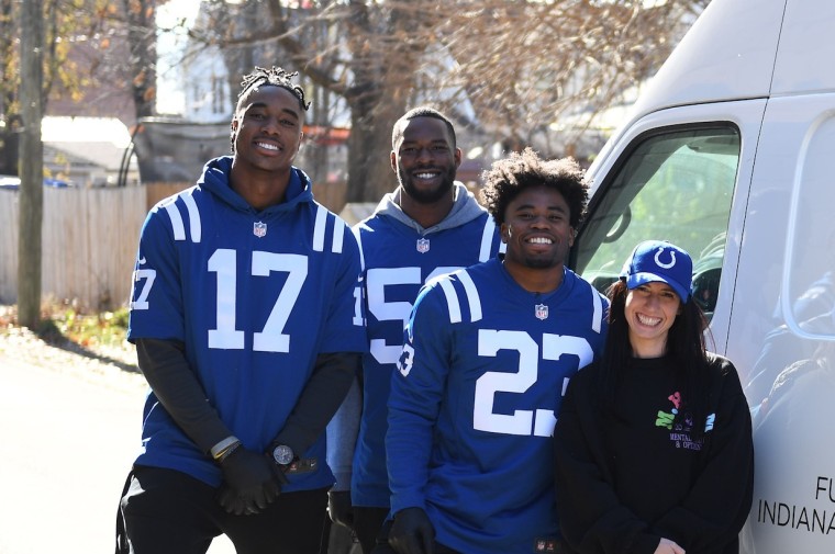 Colts owner Kalen Jackson smiles for a photo with (left to right) players Mike Strachan, Ben Banogu, and Kenny Moore II.