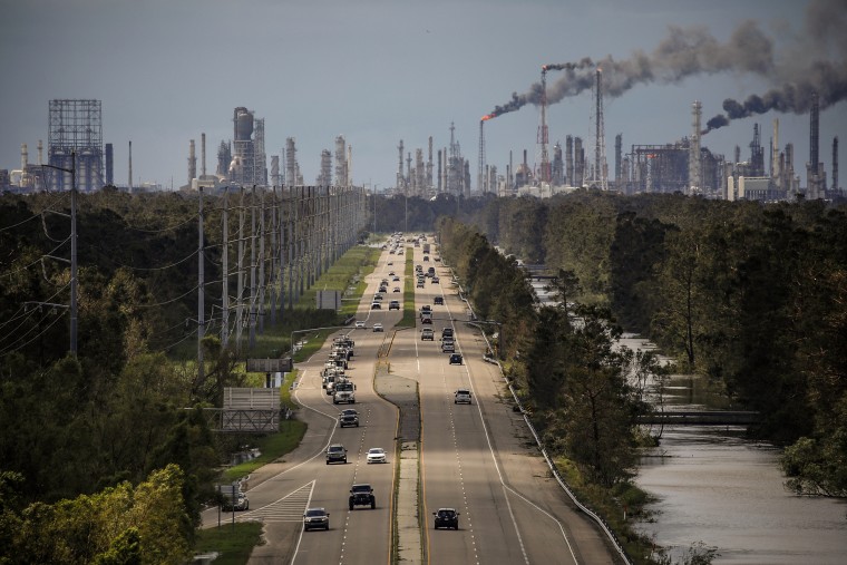 Traffic moves along a stretch of roads near the Royal Dutch Shell and Valero Energy's Norco refineries during a power outage caused by Hurricane Ida in LaPlace, La., on Aug. 30, 2021.