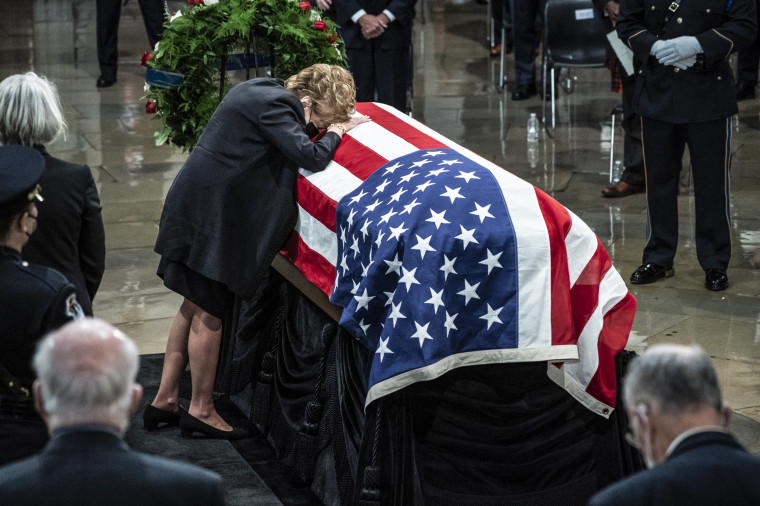 Image: Former Sen. Elizabeth Dole, rests her head on the casket of her husband, former Sen. Bob Dole of Kansas, as he lies in state in the Rotunda of the U.S. Capitol on Dec. 9, 2021 in Washington.