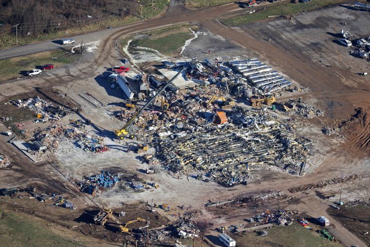 Crews clear the rubble at the Mayfield Consumer Products candle factory on Dec. 13, 2021 in Mayfield, Ky.