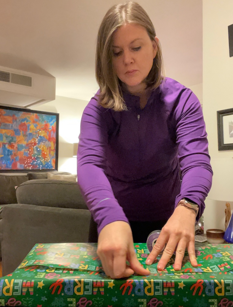 Jessica Higdon wrapping presents.