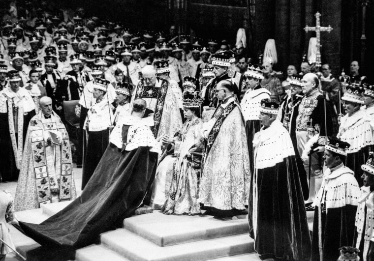 Prince Philip, the Duke of Edinburgh, kneeling, places his hands between those of Queen Elizabeth II, his wife, as he swears homage, during the Coronation ceremony in Westminster Abbey in London on June 2, 1953.
