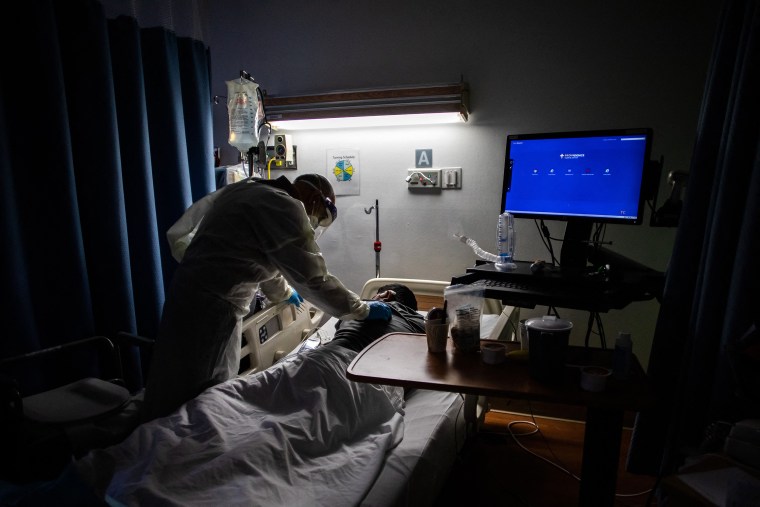 Image: Doctor Delkhah Shahin checks on an unvaccinated, Covid-19 patient at Providence Cedars-Sinai Tarzana Medical Center in Tarzana, Calif., on Sept. 2, 2021.