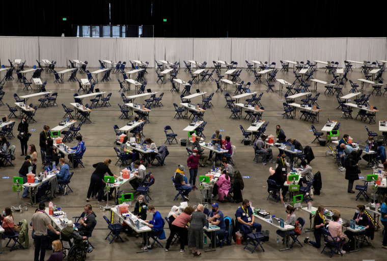 People receive their coronavirus disease (COVID-19) vaccines at a mass vaccination site at Lumen Field Event Center in Seattle