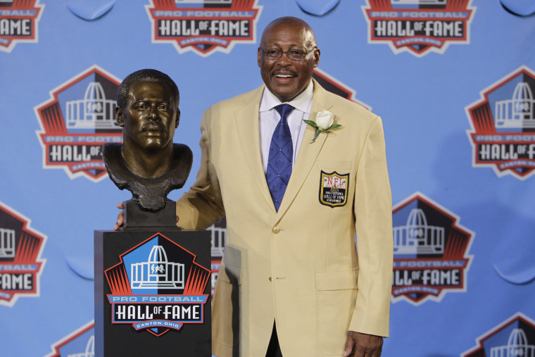 Image: Floyd Little poses with his bust after enshrinement in the Pro Football Hall of Fame in Canton, Ohio in 2010.