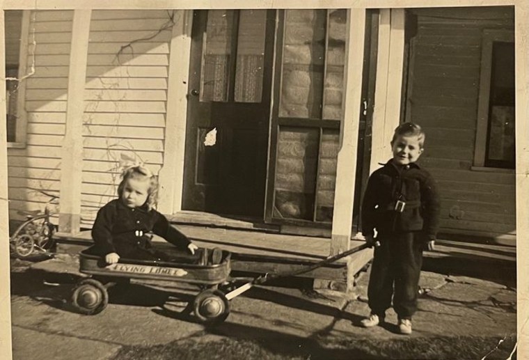 Jimmy pulling little sister, Joann, in the wagon.