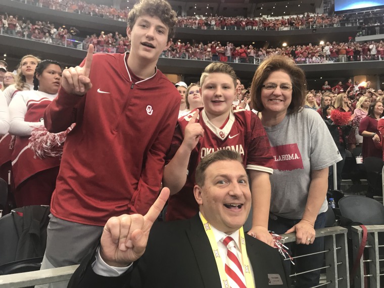 Rose Giroux Kalinski with her husband, Chris, and sons Mathew and Gavin, at a University of Oklahoma football game.