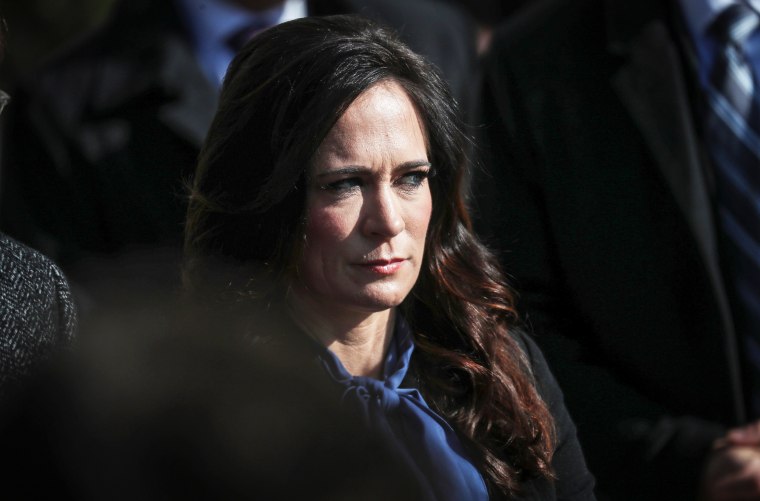 Press Secretary Stephanie Grisham listens to U.S. President Trump as he departs for travel to Georgia at the White House in Washington