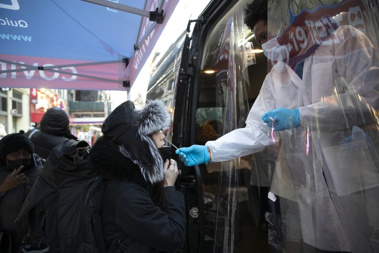 Image: A woman gets tested at a mobile Covid-19 testing van on 14th Street, in N.Y.