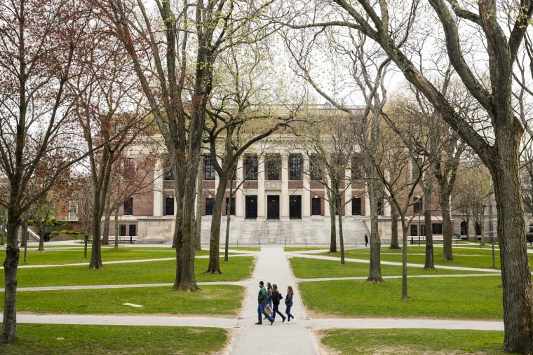 Pedestrians walk through Harvard Yard in Cambridge, Mass., on April 20, 2020.