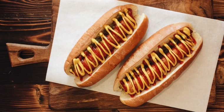 Directly Above Shot Of Hot Dogs On Paper At Restaurant
