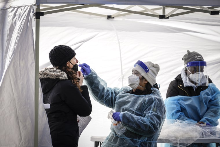 Image: A woman is tested for Covid-19 at a free testing site in Farragut Square in downtown on Jan. 10, 2022 in Washington, DC