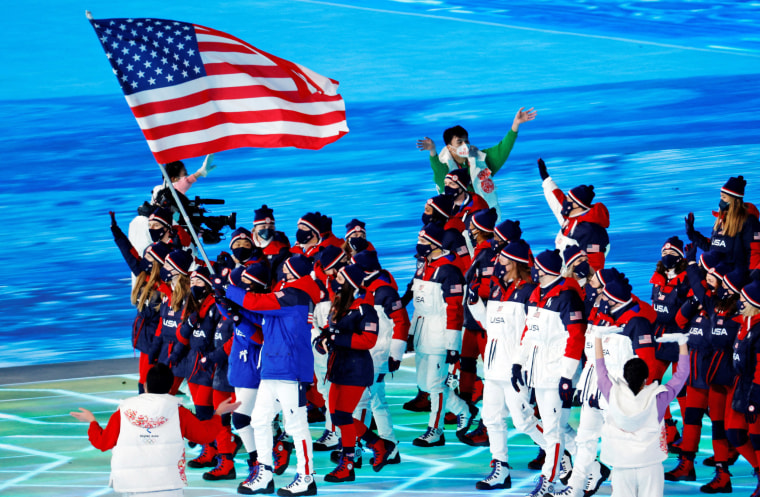 Flagbearers Elana Meyers Taylor and John Shuster lead the U.S. team during the parade of nations.