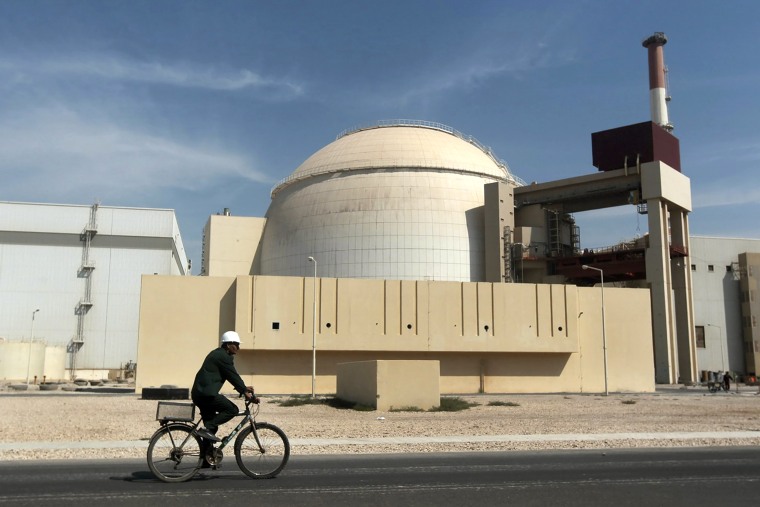 Image: A worker rides a bicycle past the reactor building of the Bushehr nuclear power plant, just outside the southern city of Bushehr, Iran, on Oct. 26, 2010.