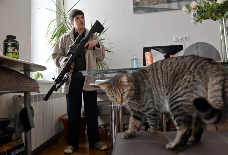 Image: Mariana Jaglo, mother-of-three, holds a rifle during an interview in Kiev.