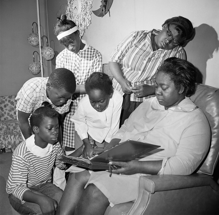Exerlena Jackson, widow of Wharlest Jackson, and her family look at a photo album on Feb. 28, 1967.